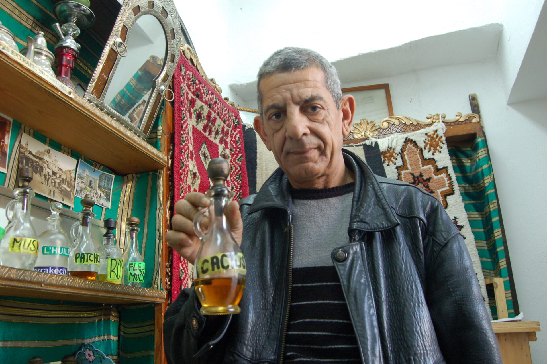 Ali showing his wares in his smal shop in the souk