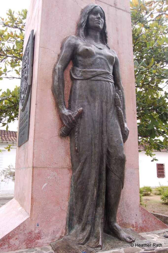 A statue of an Indigenous woman terrorized by the Spaniards