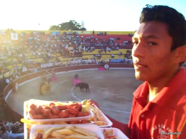 waiter serving botanas during bullfighting