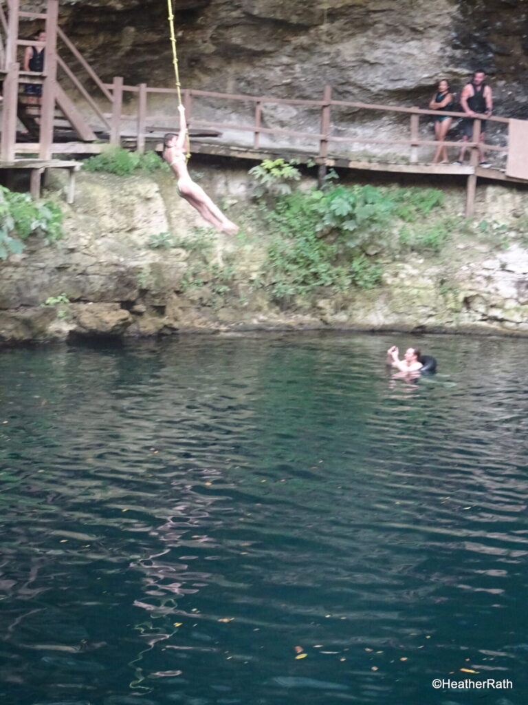 Perfect form on the Tarzan rope entering the water