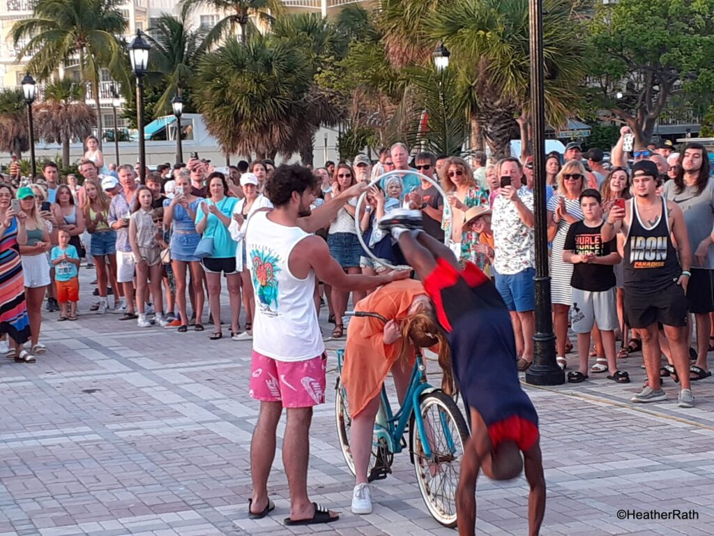 busker diving through a hoop at Mallory Square