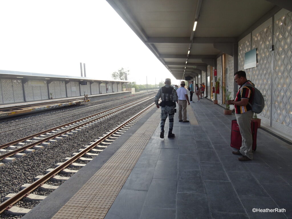on platform waiting for approaching train - not militry personnel who are responsible for the maya train