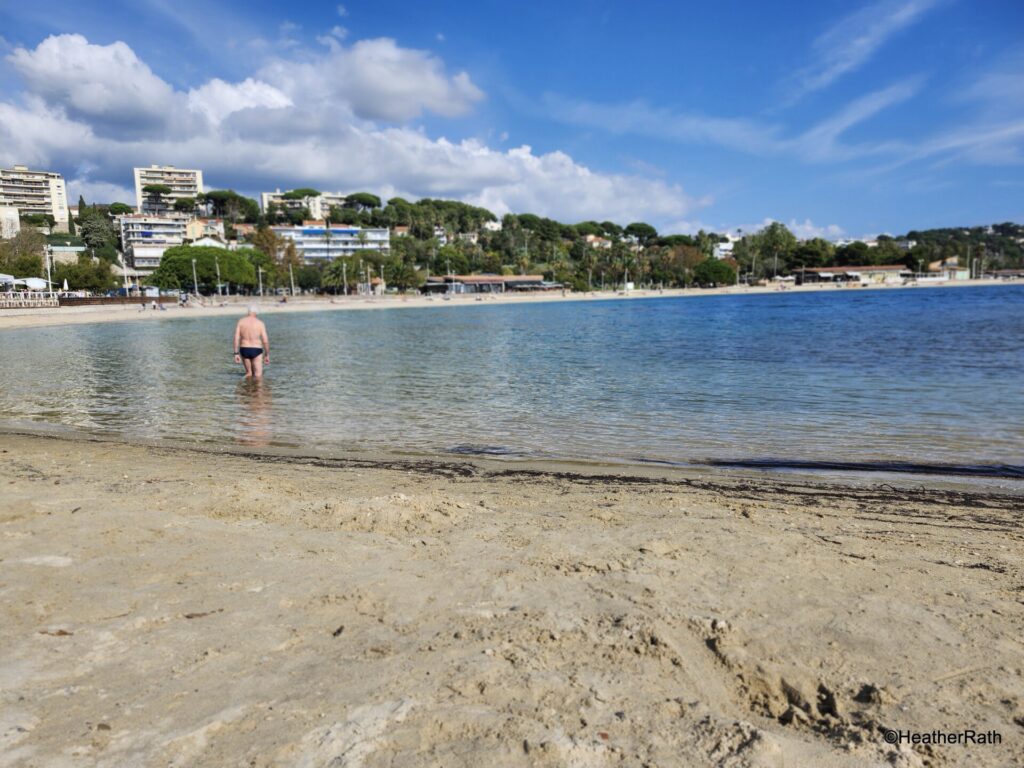 I am in the water going for a swim at a beach in Mourillon