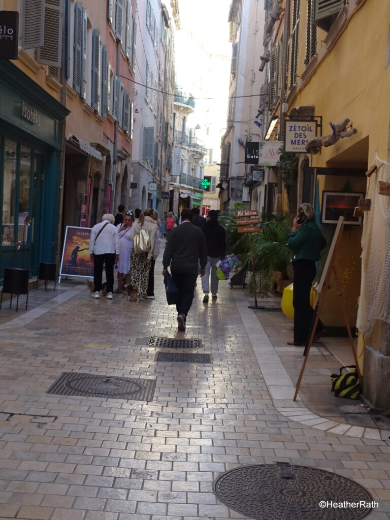 photo of street in the arts section of town with people and art displays