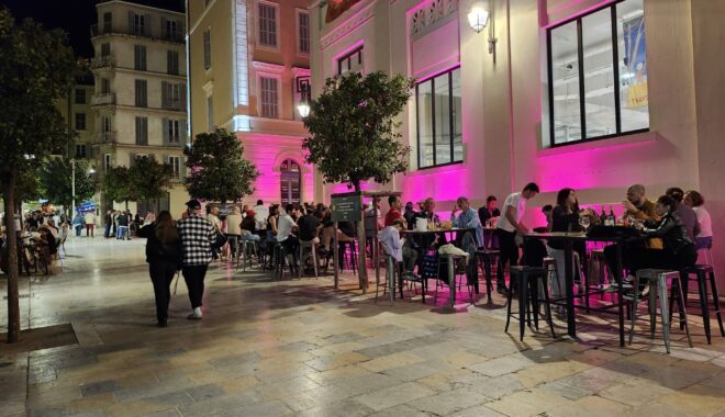 photo of people dining and drinking outside on a pleasant evening