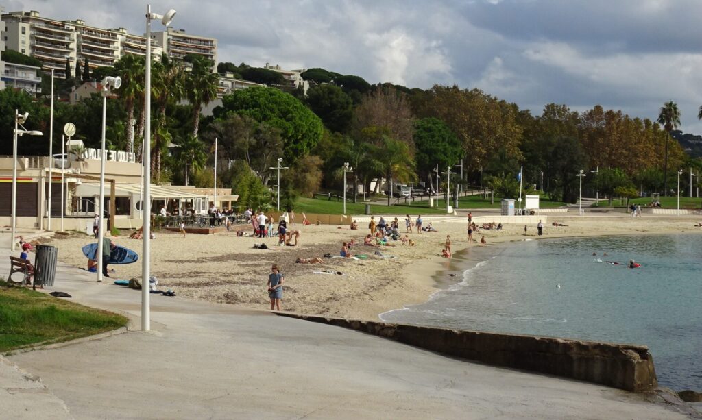 People swimming and sunning at one of the beaches in Mourillon. Late October