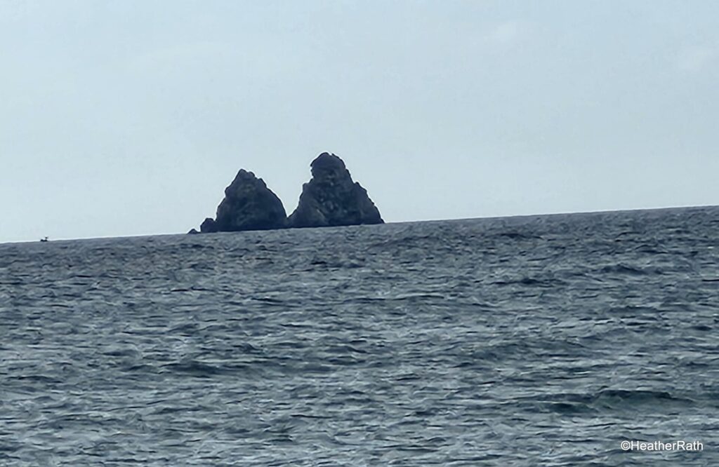 Off shore from Les Sabletes beach are Les Deux Frères large rocks breaking the surface of the sea - one of your interesting day trips from Toulon France