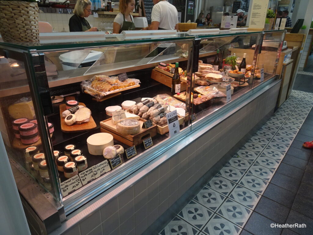 a deli counter with many tasty cured meats and meat products