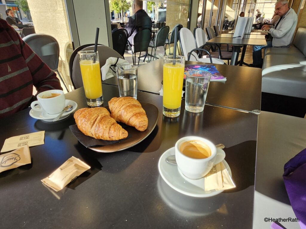 tyoical French breakfast - espresso, pastry, juice and water