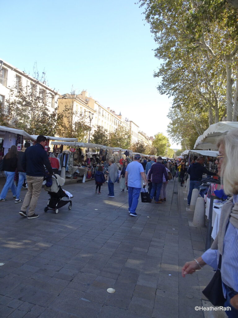 Crowds wandering a shopping at the Cours Mirabeau market