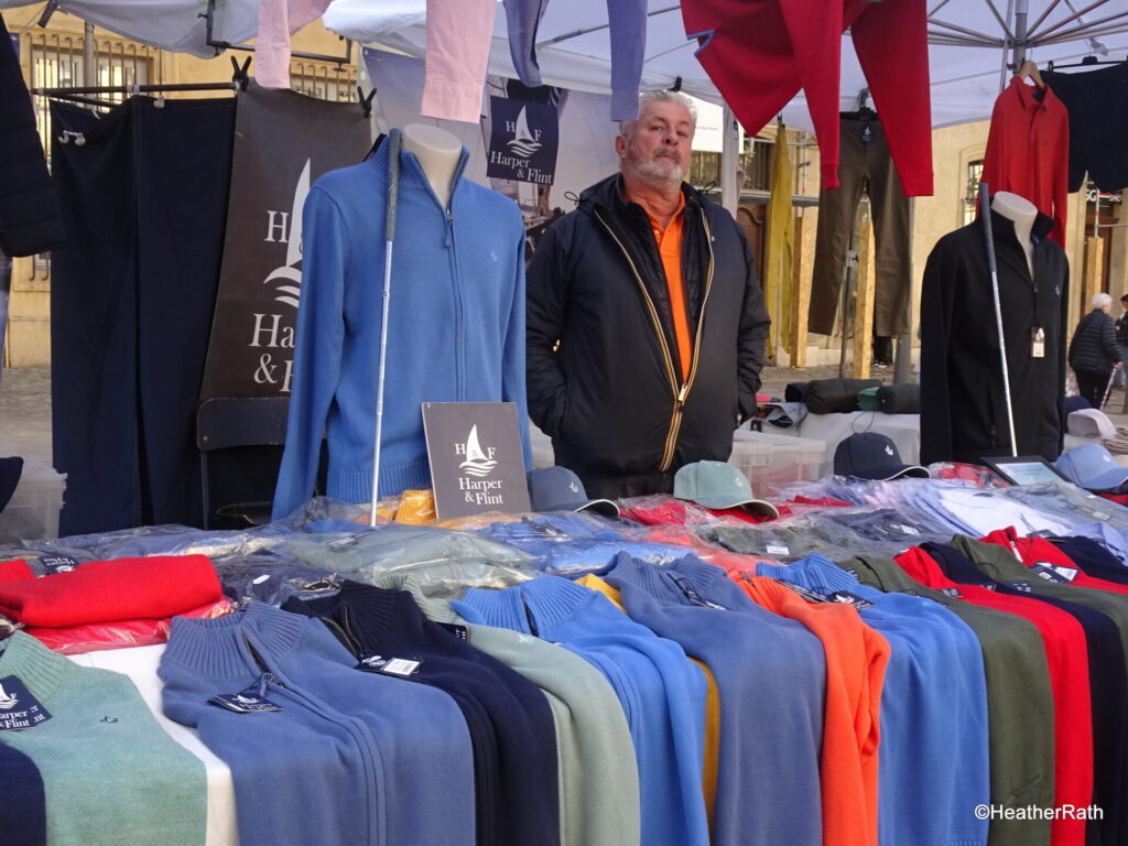 vendor selling clothes at the Cours Mirabeau Market as we spend a day in Aix en Provence