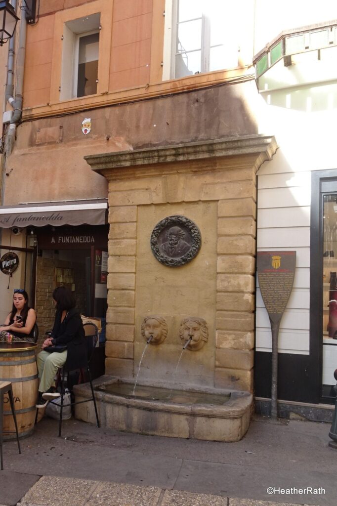 Rue des Baigniers fountain with the bronge head of Cezanne as designed by Rodin