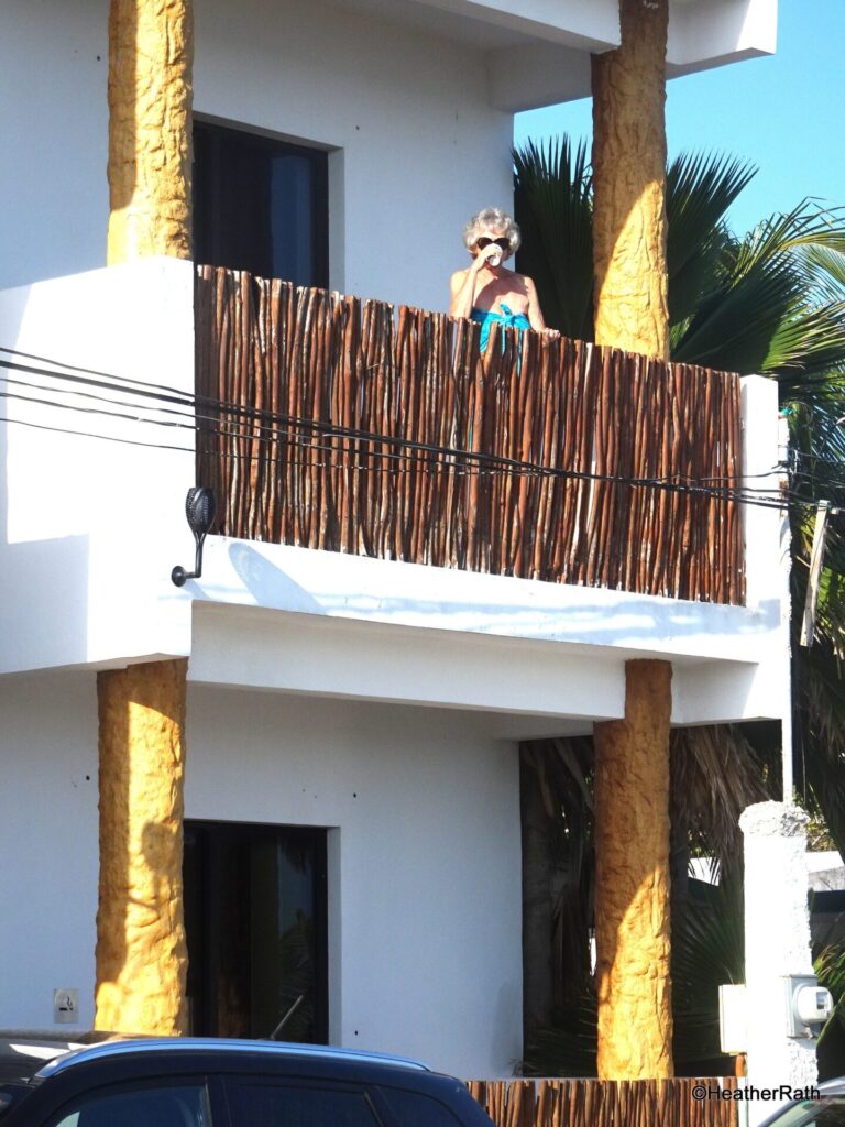pic of Heather enjoying her coffee on the balcony of our room at Casa Delfines