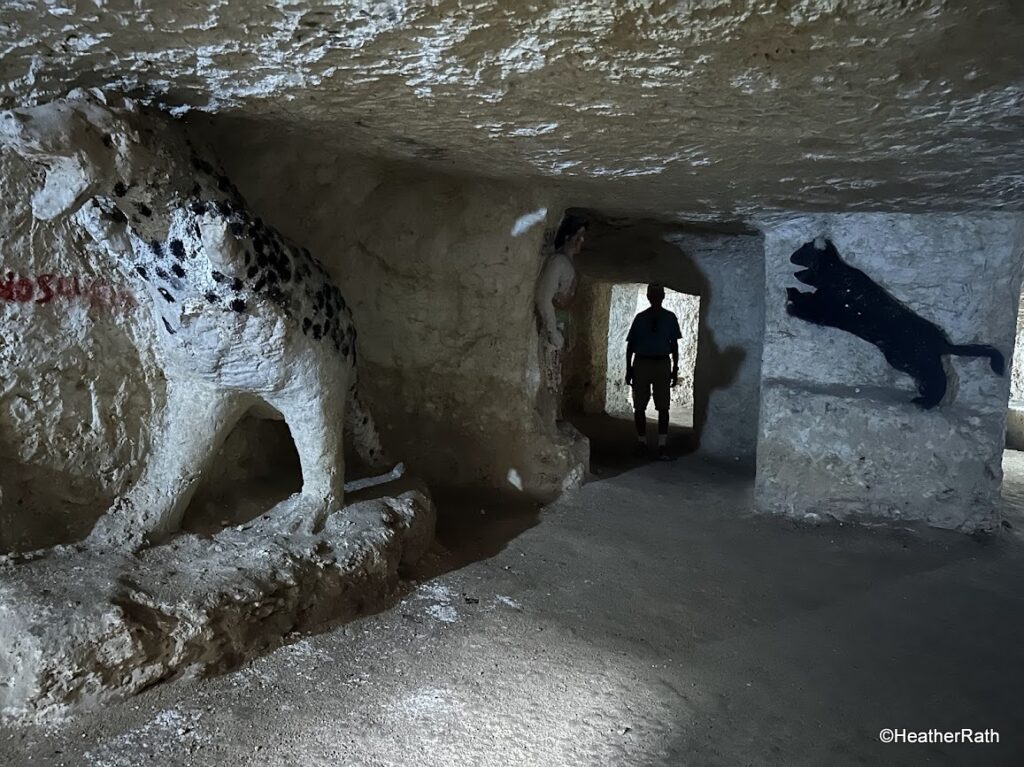 pic of Norm standing in the channel between the cells in the underground catacomb in Tizizmin
