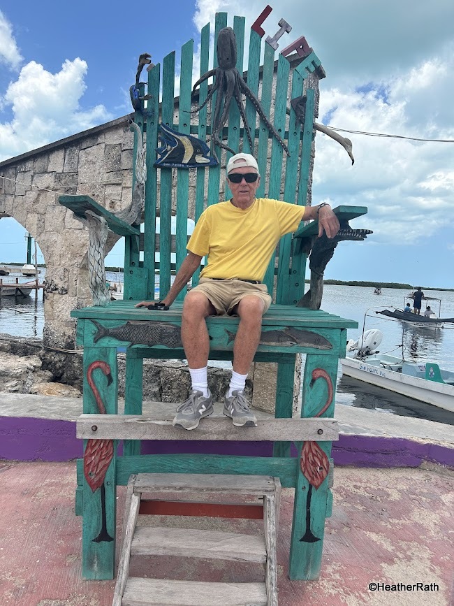 I am sitting in a too large tourist chair in San Felipe a town near Rio Lagartos Yucatan. Some of the San Felipe name at the top is missing