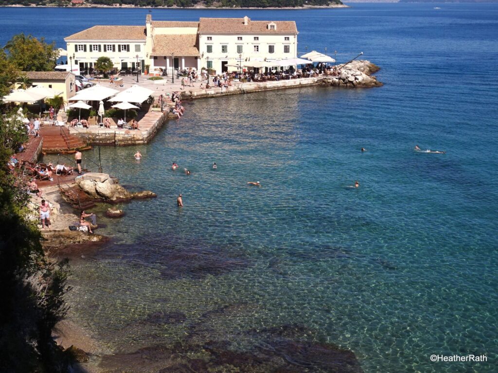 photo of people swimming and seaside bars and restaurants