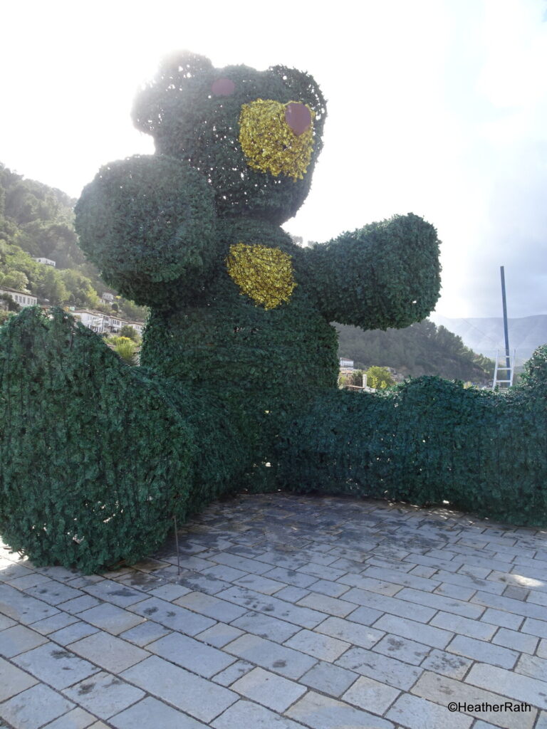 pic of a green bush trimmed to be a teddy bear