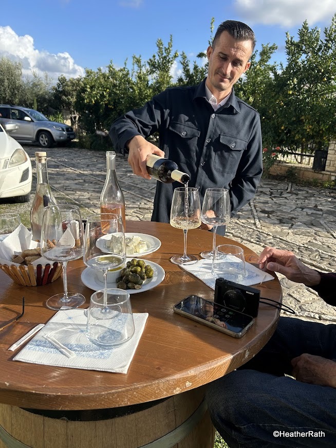 photo of server pouring a sample of white wine at Cobo Winery